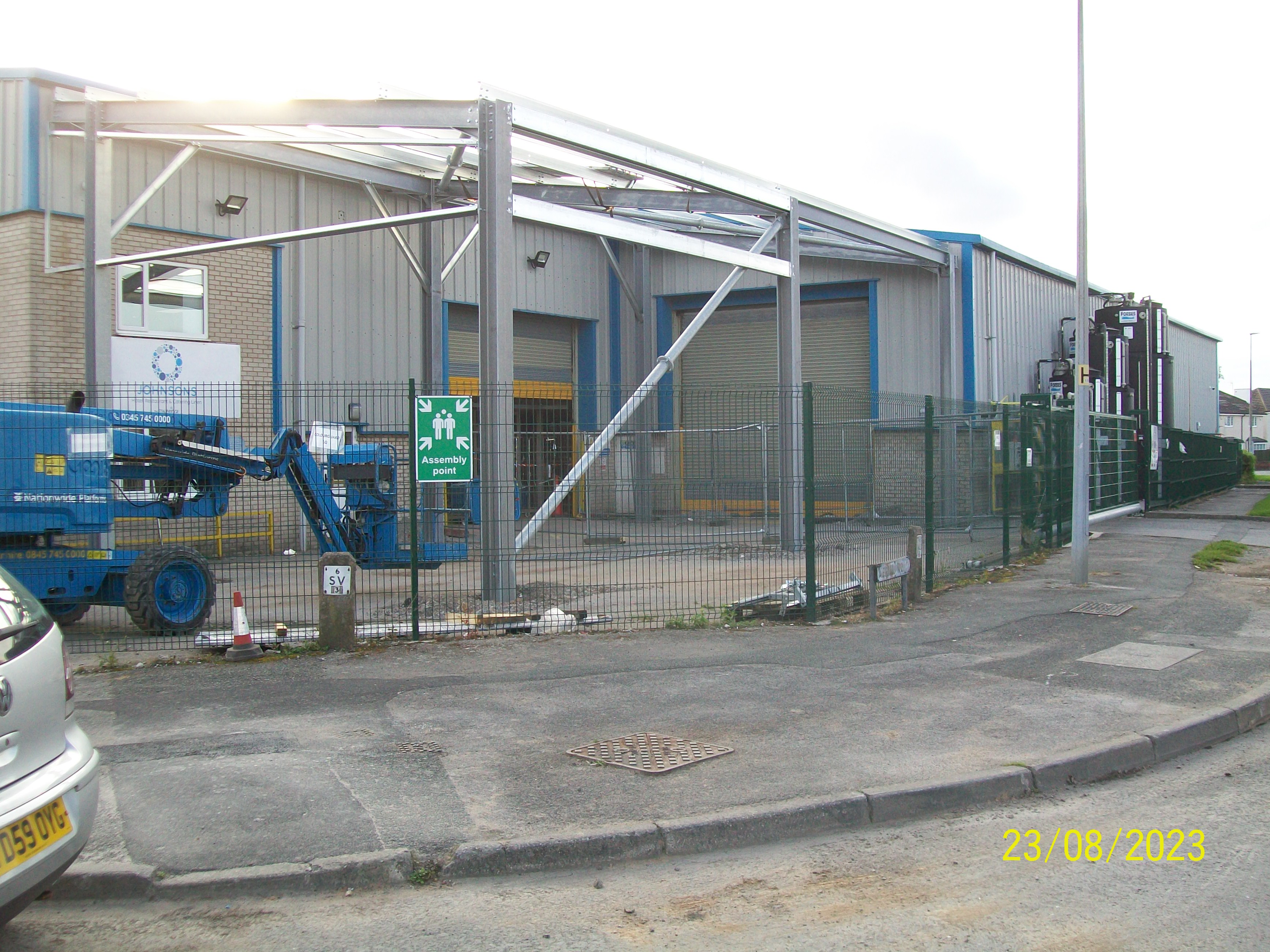 Steel canopy frame erected onto an existing building