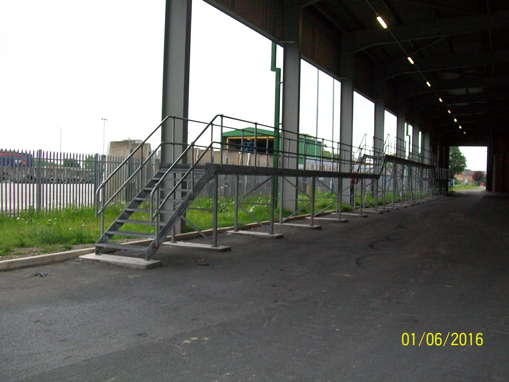 Steel walkway and staircase beneath a viaduct